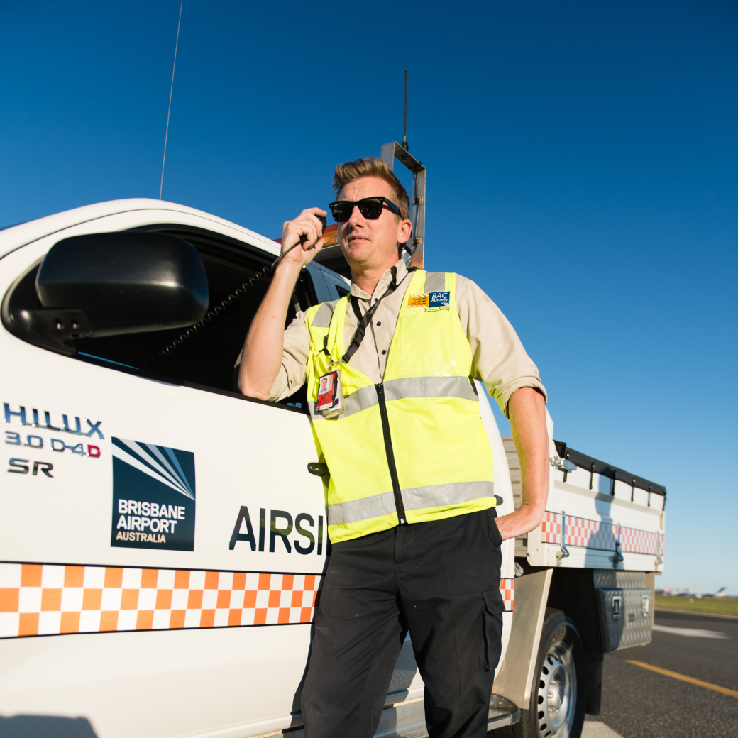 Work Safety officer leaning on small truck